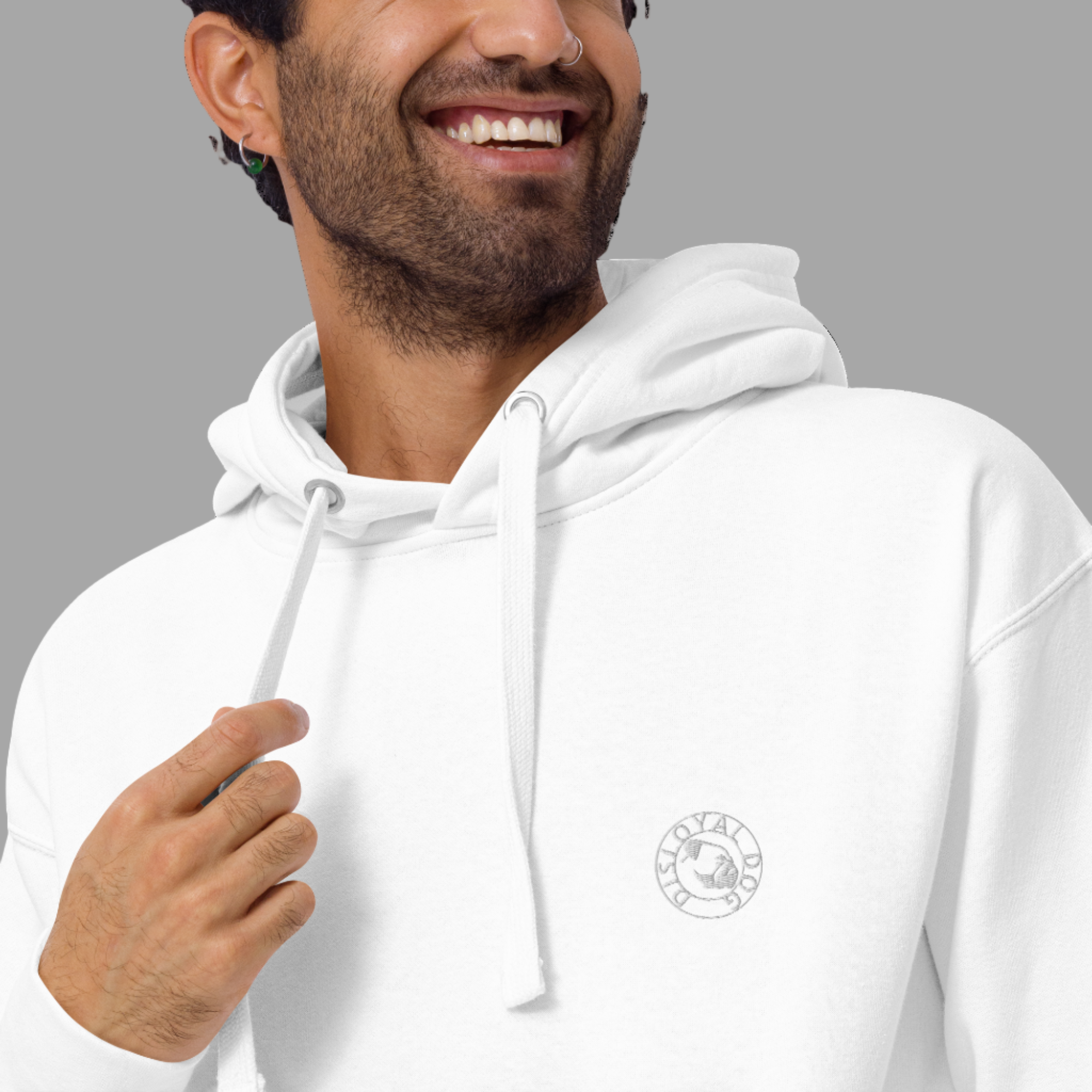 Man wearing a white Disloyal Dog pullover hoodie with a grey embroidered Disloyal Dog logo on the upper left chest.